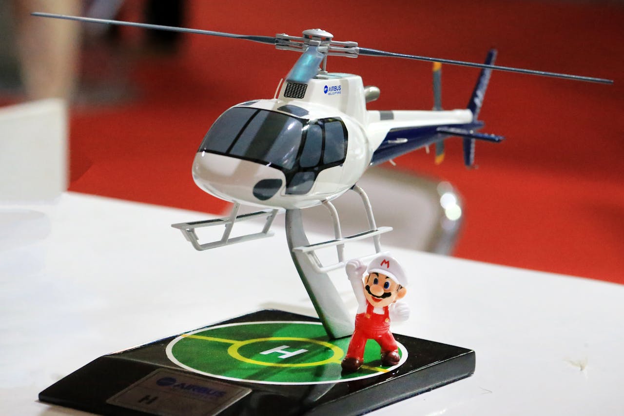Close-up of a toy helicopter model with a figurine on a table, ideal for aviation enthusiasts.