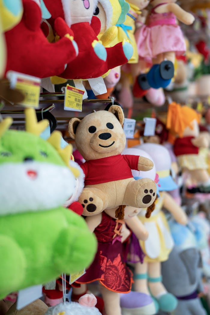 Colorful plush toys hanging in a lively retail store aisle.