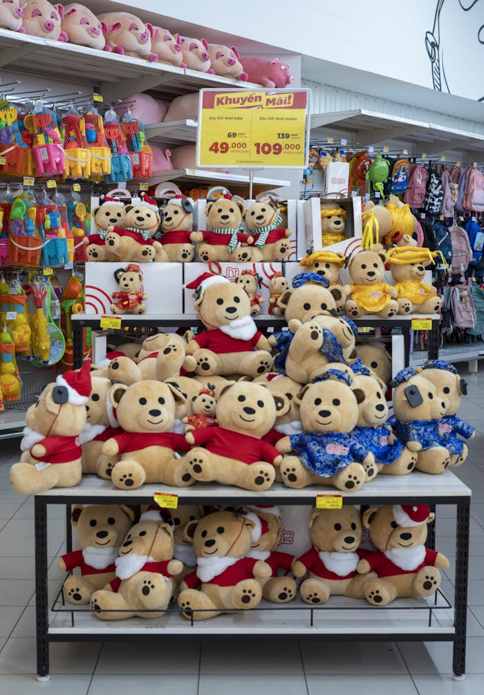 Colorful teddy bear display in a retail store offering special promotions.