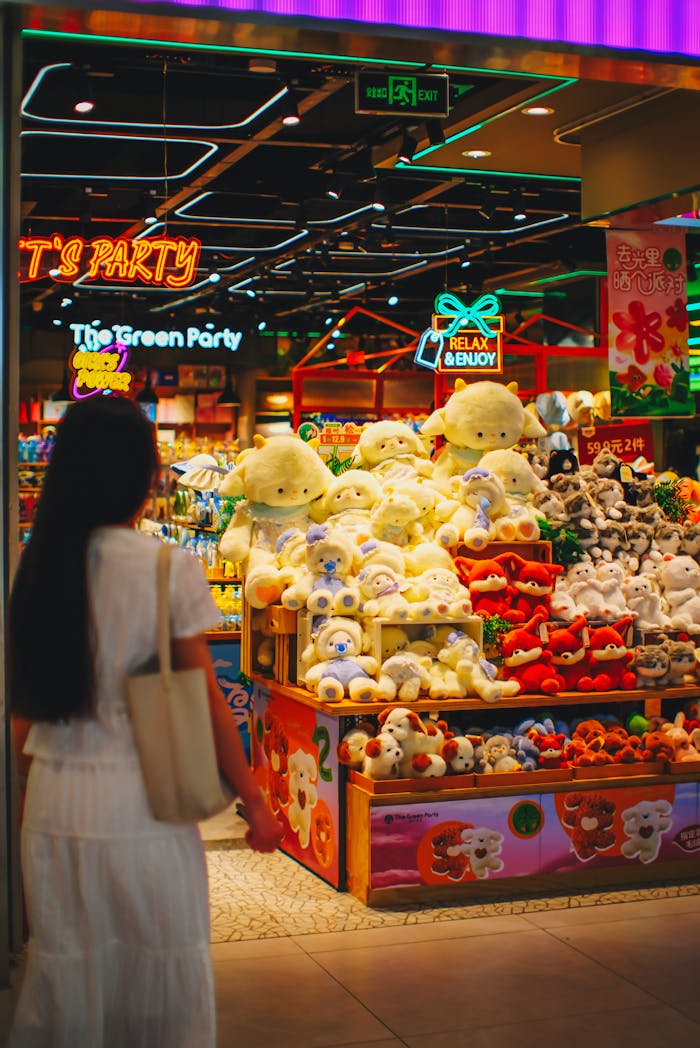 Colorful toy store display attracting shoppers in a busy mall setting.