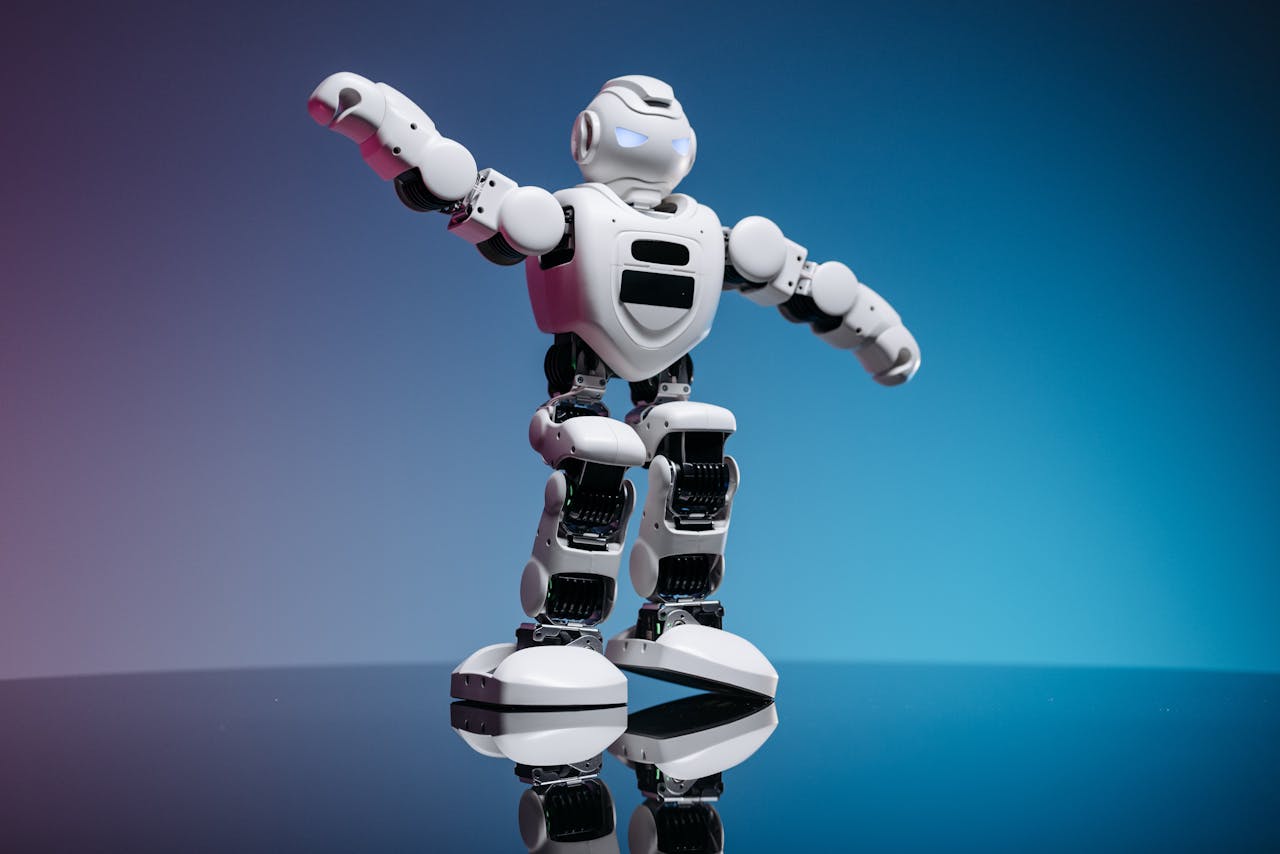 A futuristic white robot toy standing on a reflective surface with a gradient background.